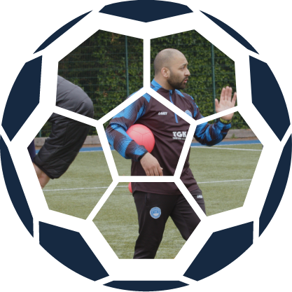 Coach holding a football during a session